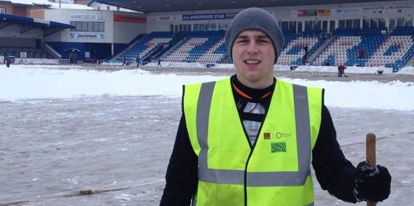 A volunteer with passion and a shovel works to get the game on.