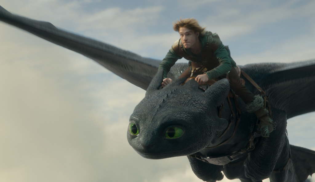Night Fury dragon, Toothless, and Hiccup (Mason Thames) in Universal Pictures’ live-action How to Train Your Dragon, written and directed by Dean DeBlois.