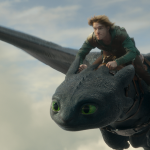 Night Fury dragon, Toothless, and Hiccup (Mason Thames) in Universal Pictures’ live-action How to Train Your Dragon, written and directed by Dean DeBlois.